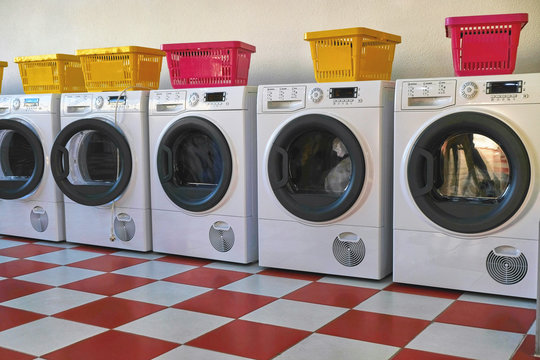 Washing Machines In The Laundromat. Room With Laundry Machines. Sunny Summer Day. No People.