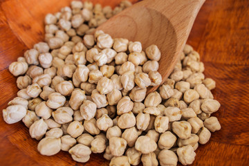 Dry chickpeas on wooden background.