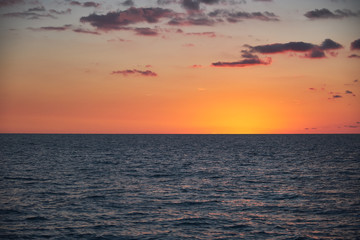 Enchanting view of the sea at sunset with beautiful clouds above it. Outdoor recreation. Non-urban scene. Travel destination.