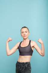 Naklejka premium fit slim and strong woman in sportswear. female power training and health.
