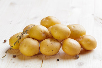 Fresh potatoes on the wood background