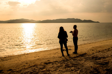 silhouette of people at the beach Beach activities The beauty of natural light at sunset.