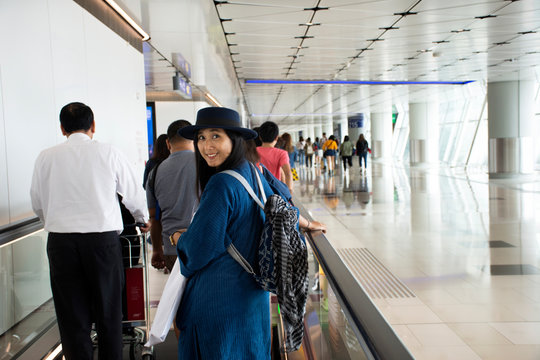 Travelers thai woman walking in terminal go to bus station at Hong Kong International Airport, Mainland China