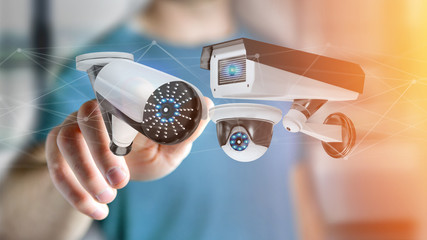 Businessman holding a Security camera system and network connection - 3d rendering