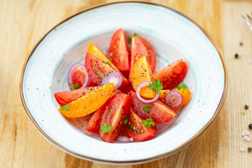 Traditional Italian salad with fresh tomatoes, onions and olive oil