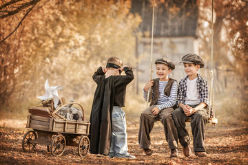 Fototapeta na wymiar Little boy dressed as superhero shows its strength the older boys