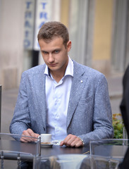 Doubt thinking businessman sitting at caffee restaurante.