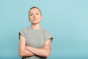 confident serious woman with crossed arms. look of defiance and self assurance.