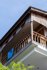 Fototapeta na wymiar Balcony of native style cottage hotel in tropical island. Beach towel on rustic guesthouse balcony