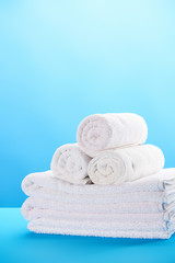 close-up view of rolled and stacked clean white towels on blue