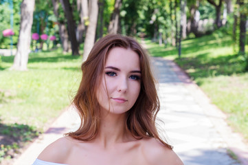 Young girl in a white dress in the park.