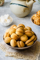 'Baci di dama': italian delicious cookies with chocolate and hazelnuts and topping on delicate background
