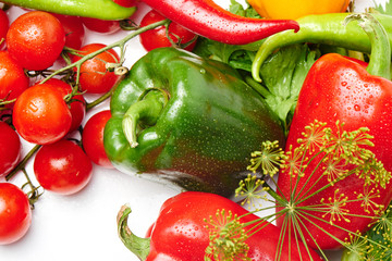 Peppers, cherry tomatoes, eggplants and dill on a white background with a copy space. Fresh multicolored vegetables..