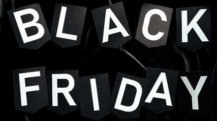 top view of black friday lettering on black background