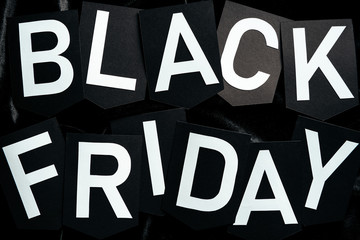 top view of black friday lettering on black background