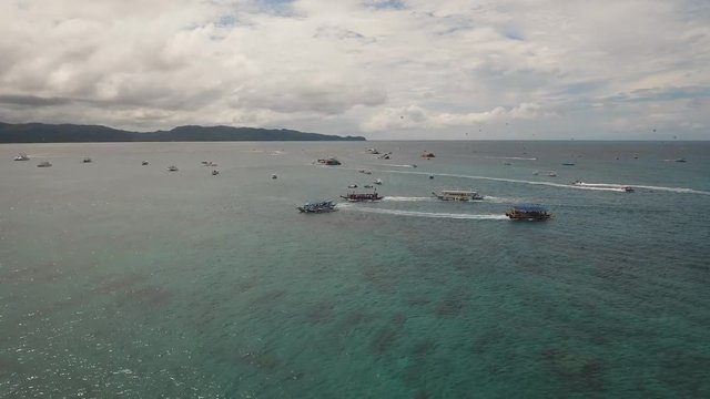 aerial view water sports and recreation on tropical island, jet ski, parasailing and boat. Philippines Boracay, aerial footage