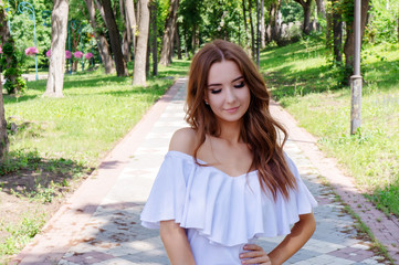 Young girl in a white dress in the park.