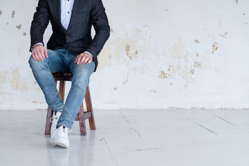 man in jacket and jeans sitting on a chair. confident business trainer or entrepreneur. smart...
