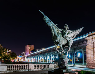 France Reborn Statue on Pont de Bir-Hakeim at night with metro in background - Paris, France