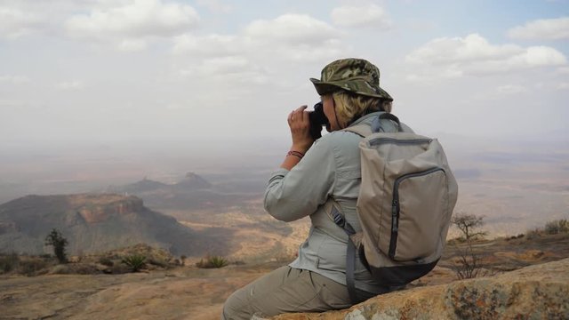 Hiker On Top Of The Mountain Takes Pictures Of The Picturesque Landscape