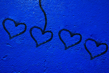 Blue painted wall background with heart signs