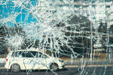 Criminal incident at the bus stop. Shooting a pistol. Hole and cracks in the glass of a city bus...