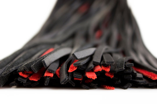 Red-black floger with leather tails on white background.concept of pleasure from pain