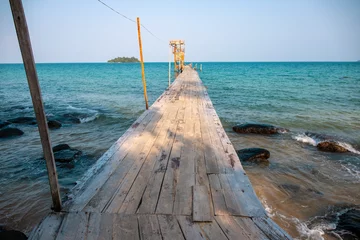 Photo sur Plexiglas Jetée Wooden pier in turquoise blue sea landscape. Empty harbor of tropical island photo. Tropical seaside landscape.