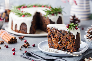 Christmas fruit cake, pudding on white plate. Christmas decoration. Close up. © annapustynnikova