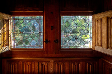 Window with view on a beautiful garden at sunny day in a medieval castle in Loire valley, France