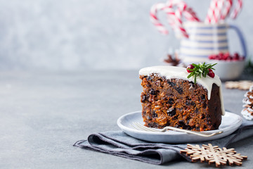 Christmas fruit cake, pudding on white plate. Traditional New Year dessert. Close up.