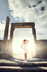 Girl in a dress on ruins. Travel, vacation, journey. Tunisia.