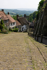 Famous Gold Hill Street in Shaftsbury on a sunny day with blue sky, England Dorset