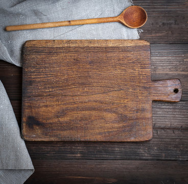 empty old brown wooden cutting board and spoon
