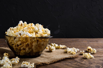 Air salty popcorn.A bowl of popcorn on a wooden table.Salt popcorn on the wooden background .  With space for text.Top view.popcorn texture.Chees .
