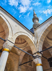 The courtyard of The Yeni Valide Camii Mosque, with a minaret in the background. Uskudar district, Istanbul, Turkey.