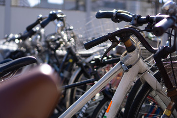 Fototapeta na wymiar Old bicycles in a bicycle parking in Japan