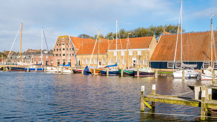 Fototapeta na wymiar Pepper House and warehouses in east harbour of city of Enkhuizen, Noord-Holland, Netherlands