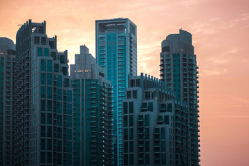 Fototapeta na wymiar Skyline, skyscrapers in Dubai. Many tall buildings at sunset, silhouettes of skyscrapers