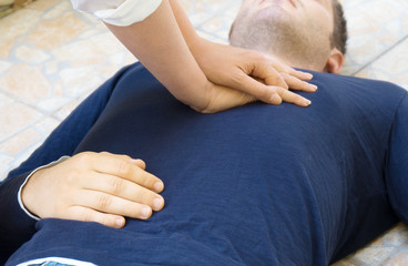 Woman doing cardiopulmonary resuscitation to a man.