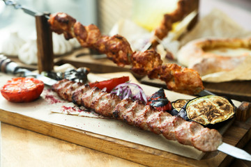 Delicious meat skewers served with grilled vegetables