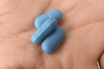 Pills om male hand, closeup