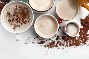 Obraz na płótnie Canvas Many cups with tasty aromatic coffee on white background
