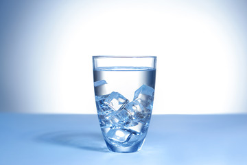 Glass of fresh cool water on table