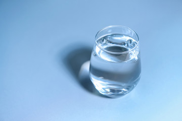 Glass of fresh cool water on table