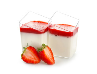 Glasses with tasty strawberry panna cotta on white background