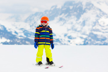 Fototapeta na wymiar Kids ski. Winter family snow sport. Child skiing