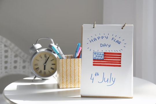 Sheet of paper with drawing of American national flag on white table