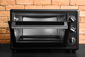 Modern electric oven on dark table