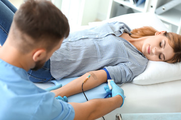 Woman donating blood in hospital